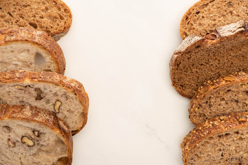top view of fresh whole wheat bread slices on white background with copy space