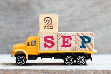Truck hold letter block in word 2sep on wood background (Concept for date 2 month september)