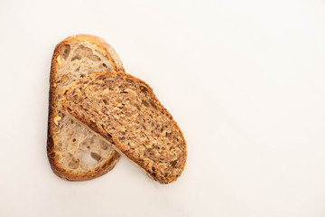 top view of fresh whole grain bread slices on white background