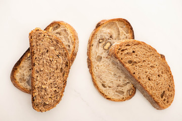 top view of fresh whole grain bread slices on white background