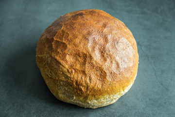 Fresh baked round bread on concrete background. Healthy, delicious and homemade food.