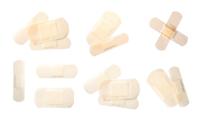 Set with sticking plasters on white background, top view