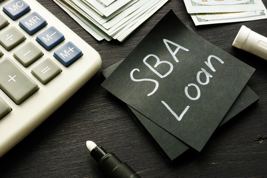 SBA loan handwritten memo on the calculator.