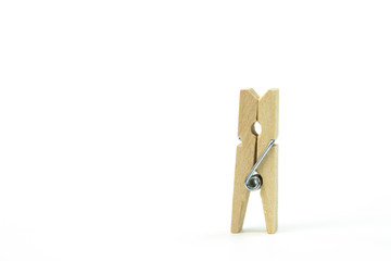 wooden clothespin, standing alone on white background. concept of loneliness . beech wood, natural materials no plastic concept copy space