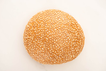 top view of fresh bun with sesame on white background