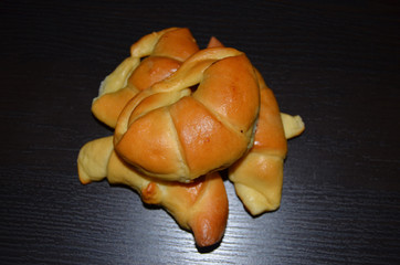 Homemade pastry. Bagel, сroissants on a dark background.