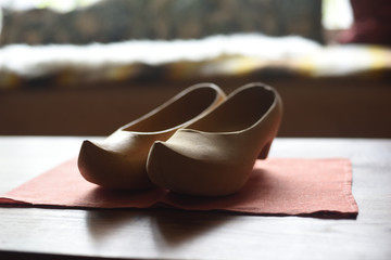 Precious wooden clogs with natural texture in a rustic home.