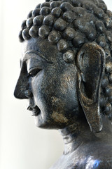 Fototapeta na wymiar The face of the Buddha on a white scene