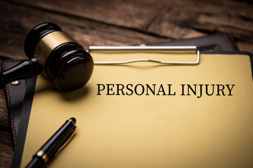 Personal Injury Law text on Document and gavel isolated on wooden office desk - 342016351
