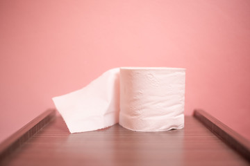Close up toilet paper on  pink backgroud.