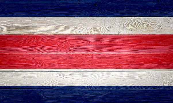 Costa Rica flag painted on old wood plank background. Brushed natural knotted wooden board texture. Wooden texture background flag of Costa Rica.