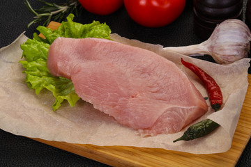 Raw Turkey steak served rosemary