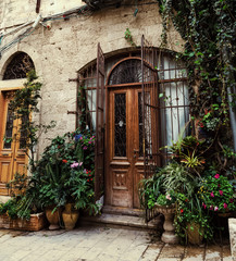 Fototapeta na wymiar entrance brown old door with pots of flowers old city Jerusalem Israel