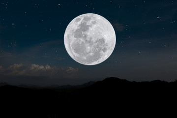 Fototapeta na wymiar Full moon on the sky over silhouette mountain.