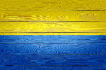 Ukraine flag painted on old wood plank background. Brushed natural light knotted wooden board...