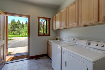 Laundry room interior in a country style American home with old washer and dryer.
