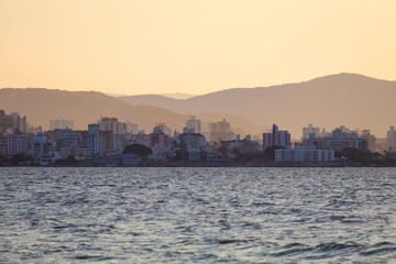 Fototapeta premium Row of buildings on the coast of Florianópolis at sunset, Santa Catarina, Brazil