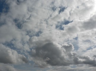 Beautiful blue sky with clouds background. Sky clouds. Air and fluffy clouds in the blue sky on a sunny day, background texture. Copy space for your text.