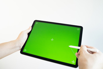 Hand draws a pencil on a tablet with a chromakey on the screen.