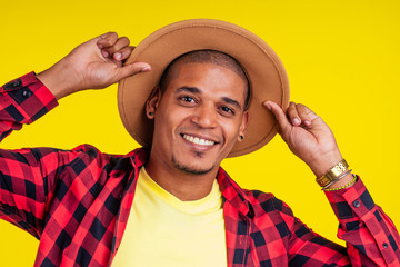 arabic brazilian man posing at studio in yellow background