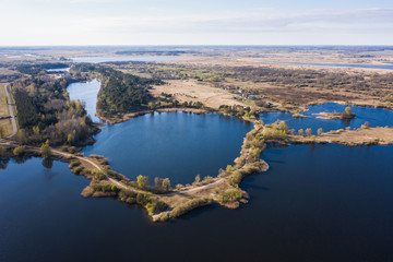 Aerial drone photo of a round blue lake surrounded by land, in the form of an eye. View from height.