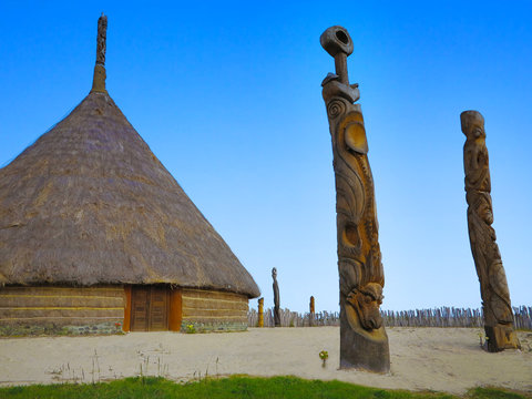 Typical Kanak house in New Caledonia with sculptures from the life of the local people.