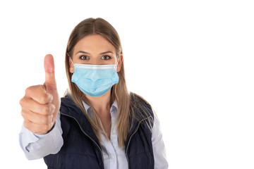 Woman with mask showing thumbs up