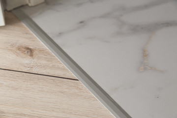 Aluminium platband for laminate and tile floor joints, floor connector, decorative strip or sill.