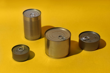 Non-perishable canned goods on colorful background. Pandemic kit staple. Food food staples prepared to survive Coronavirus COVID 19 pandemic at the time of quarantine and home isolation.