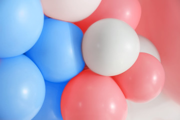 Beautiful colorful balloons on light background, closeup. Party decor