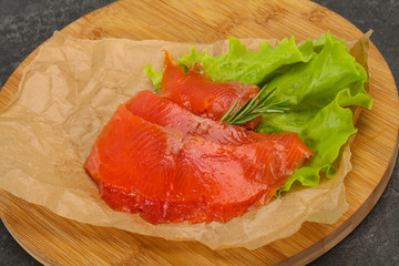 Sliced salmon fillet served rosemary