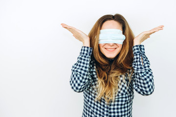 An emotional girl in a medical mask on a white background. how to protect against coronavirus? Girl...