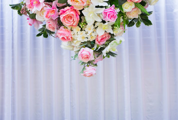 White, pink, and red roses arranged beautifully in a triangle for the background.