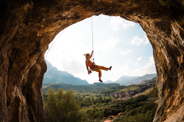 Rock climber hanging on a rope, - obrazy, fototapety, plakaty