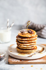 Healthy breakfast, homemade classic american pancakes with maple syrup,  served with  fingerfood sticks. Stack of small pancakes with bamboo brochettes