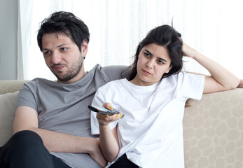 Cropped shot of a young couple watching television at home