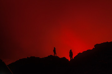 Tourists at the edge of volcano crater in Congo