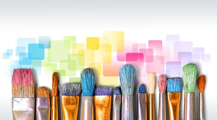 A row of artist paint brushes on desk