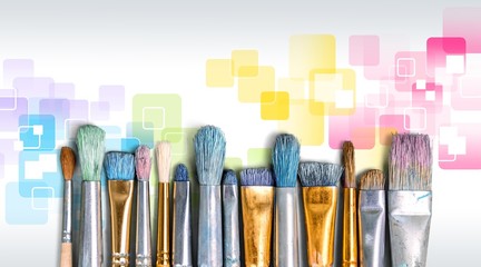 Row of artist paint brushes on background