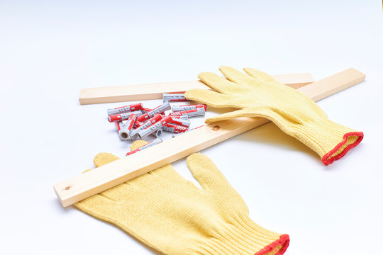 Kevlar Protective Gloves And Screws On A White Background