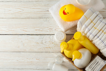 Baby hygiene accessories on wooden background, top view
