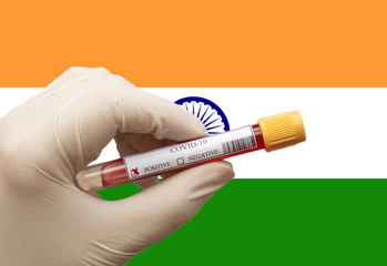 COVID-19 Pandemic Coronavirus concept ; Close-up of a Positive COVID-19 blood test sample tube with Flag of India at background. Blood testing for diagnosis new Corona virus infection.