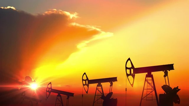 Oil pump rockers working at sunset, oil production company, energy industryю Loopable background


