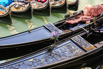 Close up of a wooden boat a black gondola in Venice in Italy on the green channel © Liza