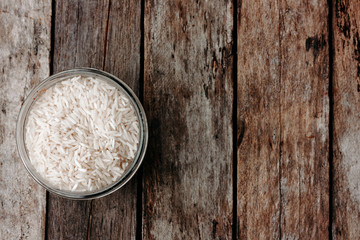 Rice in a glass jar on wooden table. Ingredients for italian risotto. Top view, space for text