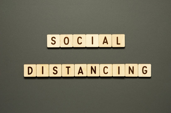 SOCIAL DISTANCING - words from wooden blocks with letters. Top view on gray background. - Image - Powered by Adobe