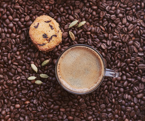 Roasted coffee beans, froth coffee mug, cookies