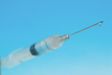 A close up of an injection with a sharp needle tip.