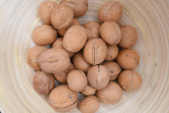 Handfull of Walnuts on a wooden plate