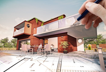 Belle maison moderne d'architecte en bois concept écologie avec main qui dessine